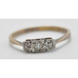 A stamped 18ct gold and platinum ring being illusion set in platinum with three with stones.