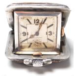 A vintage 1930's folding watch having a brown leatherette case with a square watch face within