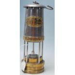 A early 20th century antique E. Thomas & Williams Ltd miners safety lamp with metal and brass