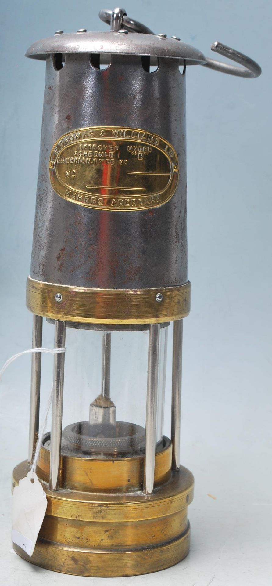 A early 20th century antique E. Thomas & Williams Ltd miners safety lamp with metal and brass