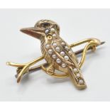 A late 19th Century 9ct gold brooch in the form of a kookaburra perched on a branch being set