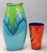 A vintage retro Poole pottery vase being glazed with blue green together with a smaller vase