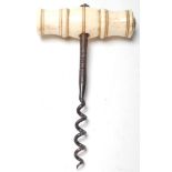 A 19th Century Victorian antique corkscrew bottle opener having a turned bone handle with a metal