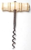 A 19th Century Victorian antique corkscrew bottle opener having a turned bone handle with a metal
