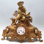 An early 20th Century French Rococo Revival gilt and spelter mantel / mantle clock depicting a young