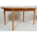 A retro vintage late 20th Century teak wood extendable dining table of oval form opening to reveal