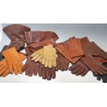 A good collection of early 20th century sorted brown leather gloves with metal buttons and leather