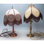 A pair of 1920s early 20th Century Style table / desk lamps having brass bases, shaped stems, fabric