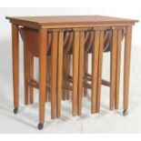 A retro vintage mid 20th century teak nest of tables in the manner of Carlo Jensen. The nest