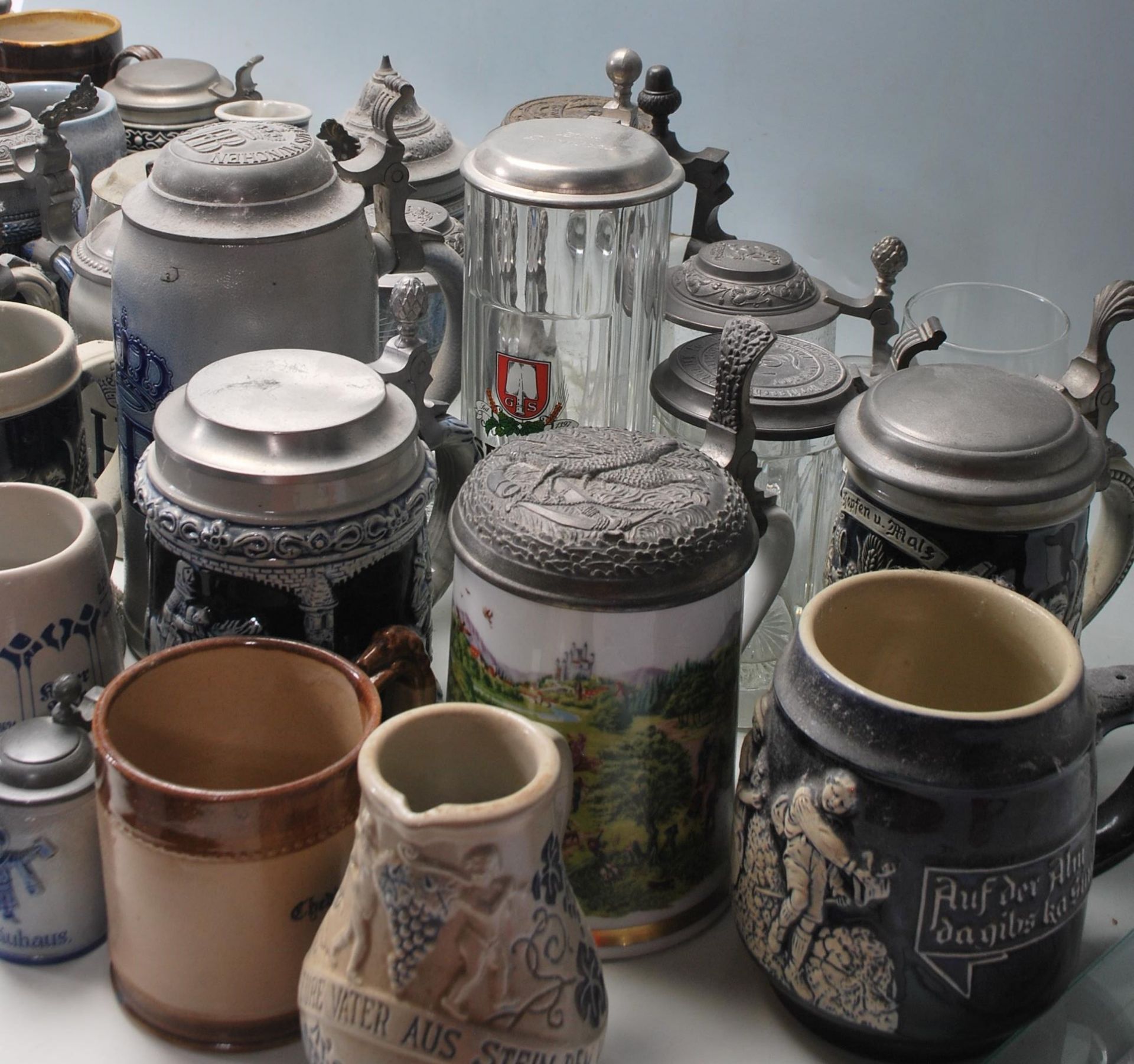A collection of 20th Century German ceramic stein drinking glasses, each having raised decoration to - Bild 5 aus 10