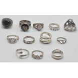 A group of ladies silver ring to include a ring set with  large faceted blue stone, a ring set