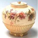 A Royal Worcester Ivory Blush lidded pot - vase. Hand painted detailing with embellished gilded foot