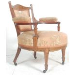 A late Victorian 19th century mahogany inlaid armchair. Raised on square tapering legs with
