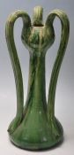 A vintage 20th Century French studio pottery vase having three curved handles to the top with a