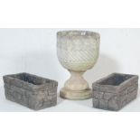 A group of three early 20th Century reconstituted stone garden planters to include a round planter