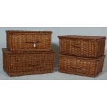 A collection of 4 vintage wicker baskets each having a hinged lid to the top with leather straps