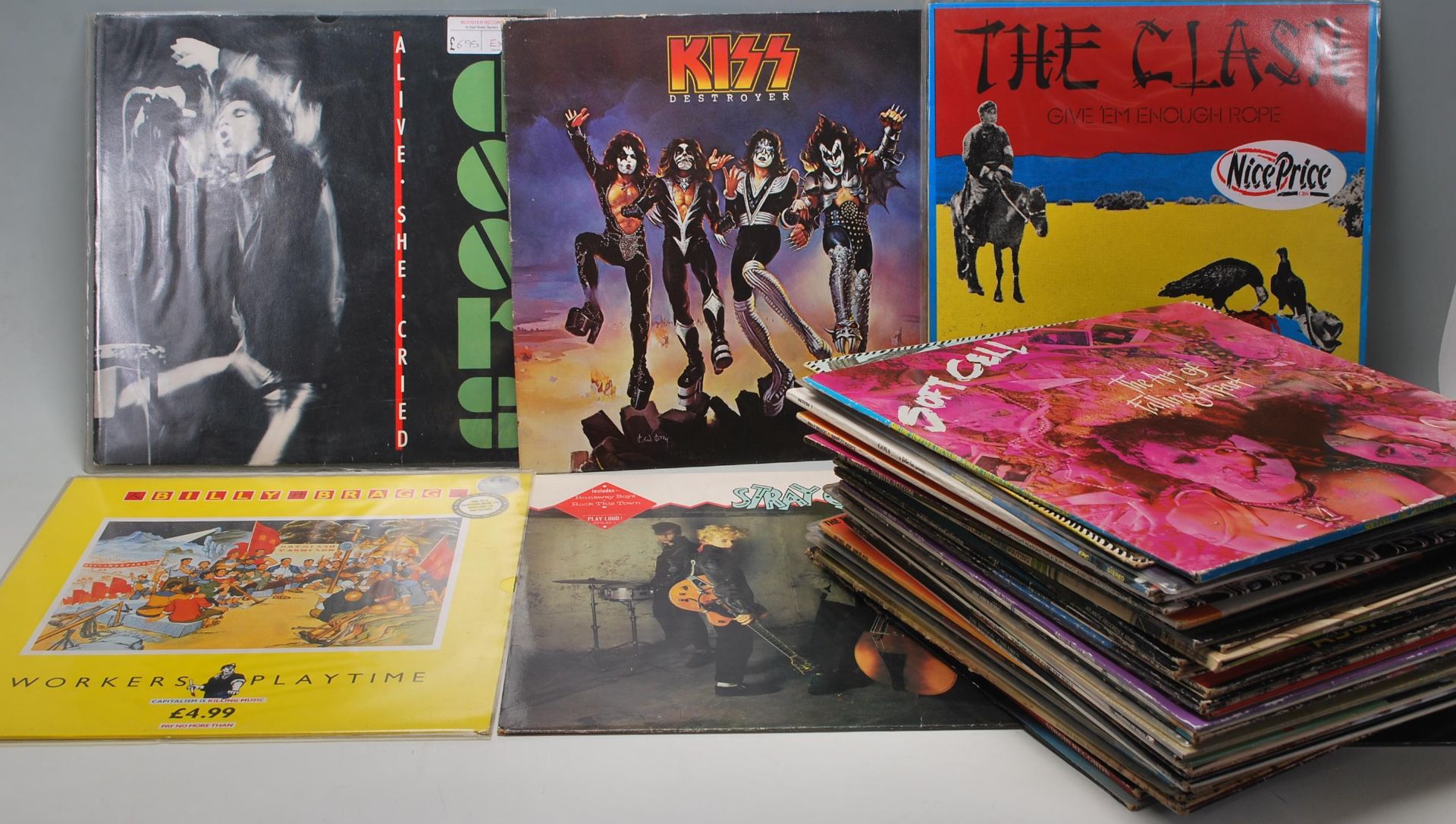 A collection of vintage records / 78's to include The Doors, Kiss, The Clash, Billy Bragg, Stray