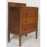 A good 1930's Queen Anne revival oak chest of drawers. The chest being raised on squared legs with