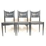 A set of three vintage retro 20th century G plan chairs having black faux leather seat and backrest,