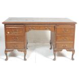 A 1940's large oak Queen Anne revival oak twin pedestal office desk. Each pedestal being raised on