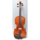 An antique vintage 4/4  violin complete in the canvas carry case along with bow. The strung violin