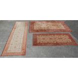 A set of three late 20th century Super Taj brown carpet rugs with geometrical pattern and light