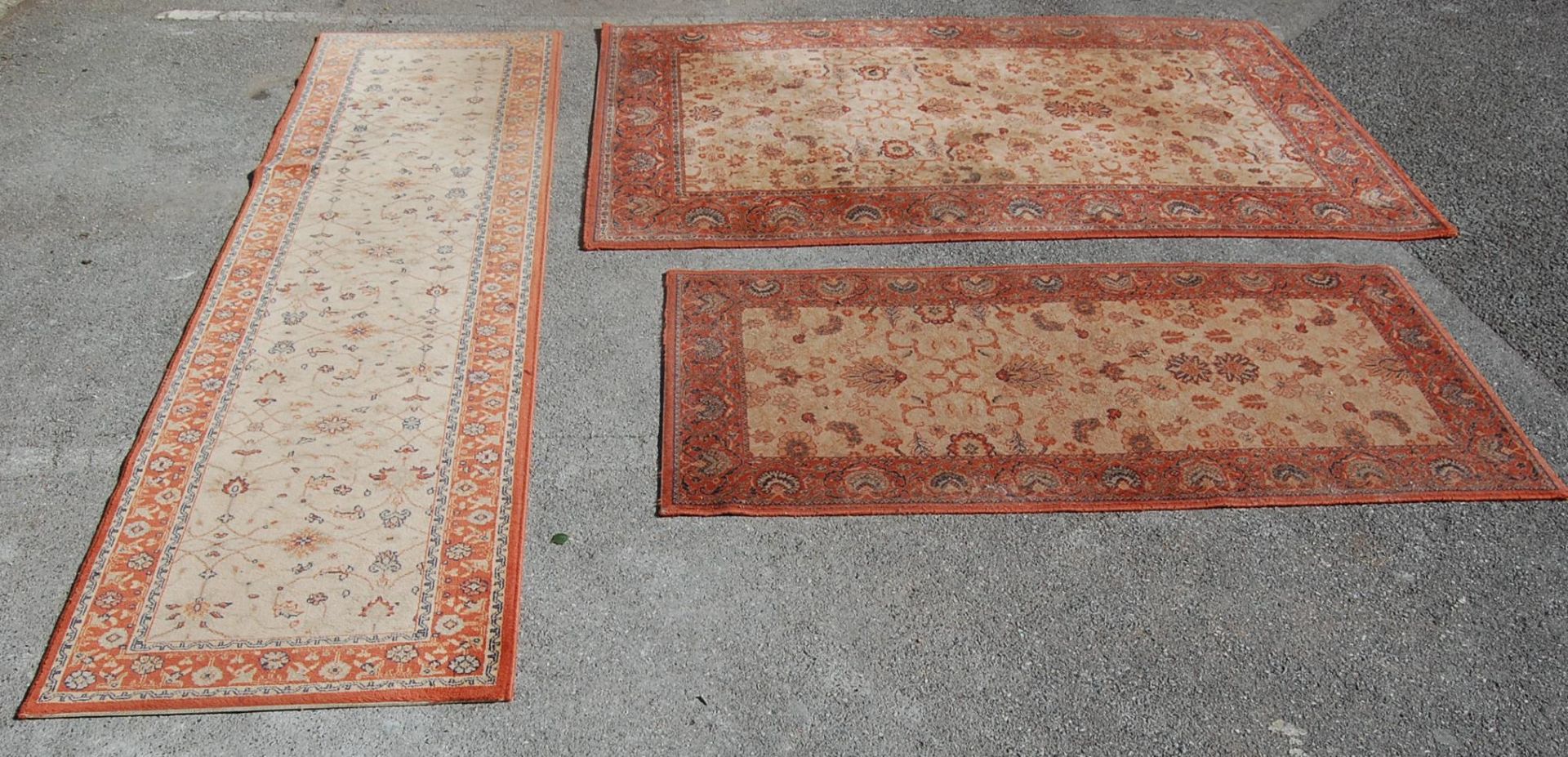 A set of three late 20th century Super Taj brown carpet rugs with geometrical pattern and light