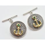 A pair of sterling silver gentleman's cufflinks having embossed yellow metal anchors and green stone