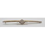 An 18ct gold bar brooch having a central diamond shaped panel set with four round cut diamonds in