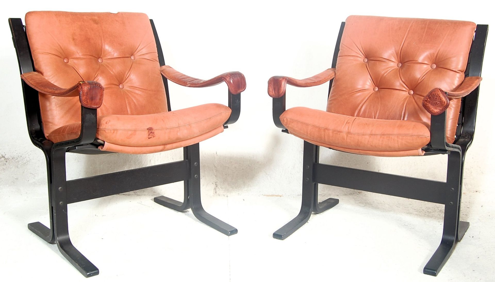 An amazing pair of retro vintage 20th century Danish inspired armchairs having black ebonies