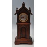 A 20th Century German wooden cased miniature longcase / grandfather clock having a pediment top with