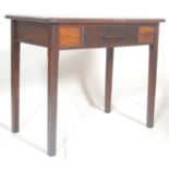 An mid 20th Century 1940s oak writing desk having a chamfered sloping top over a single drawer