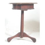A Victorian 19th century carved oak inlaid tripod games table. Raised on splayed feet with an