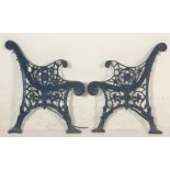 A pair of 20th Century antique cast iron scroll work garden bench ends painted in blue.