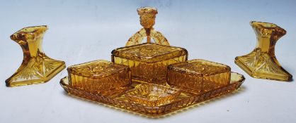 A vintage retro amber cast glass Art Deco 1930's dressing table set of diamond shape to include