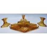 A vintage retro amber cast glass Art Deco 1930's dressing table set of diamond shape to include