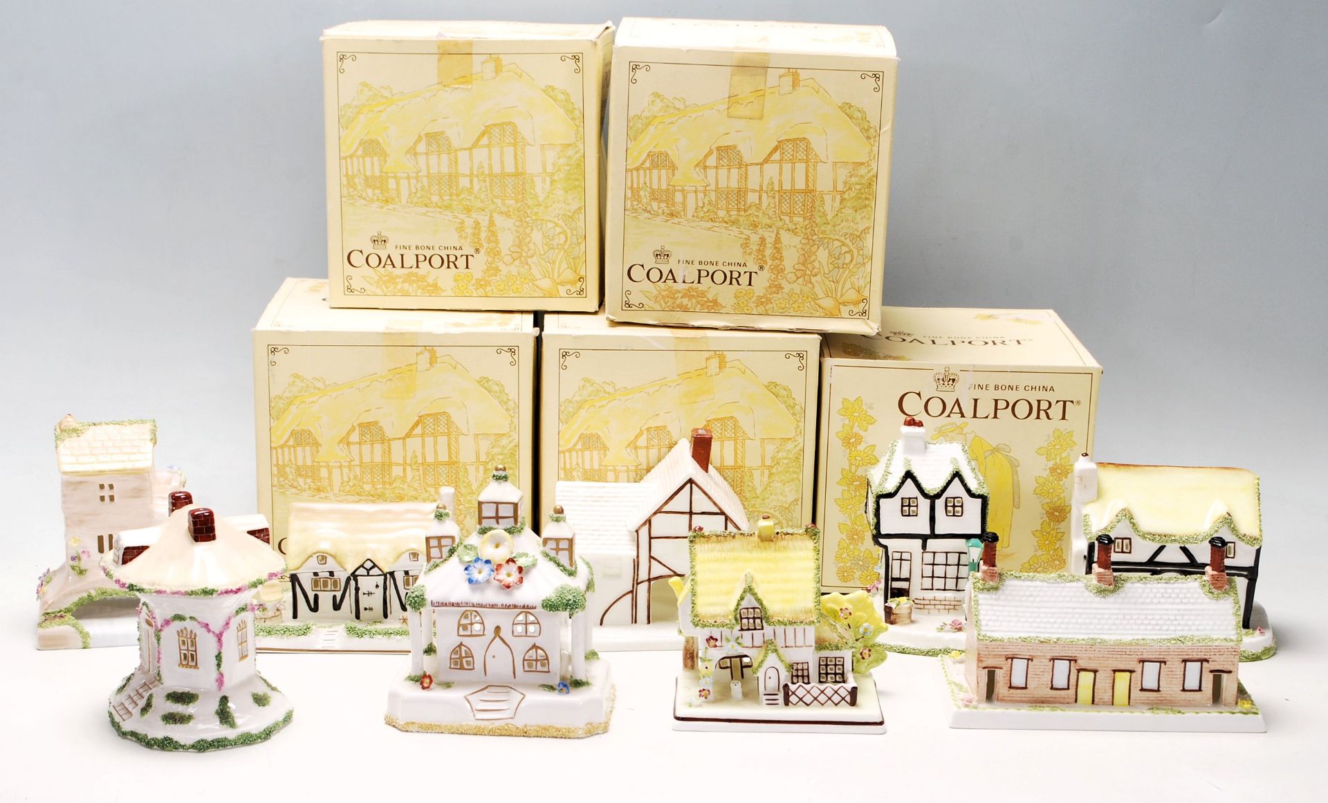 A collection of fine bone china cottages and florals by Coalport to include The Coaching Inn,