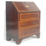 An Edwardian mahogany inlaid bureau desk. Raised on bracket feet with an upright body comprising a