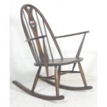 A contemporary 20th century Ercol Furniture beech and elm wood Windsor pattern rocking chair -