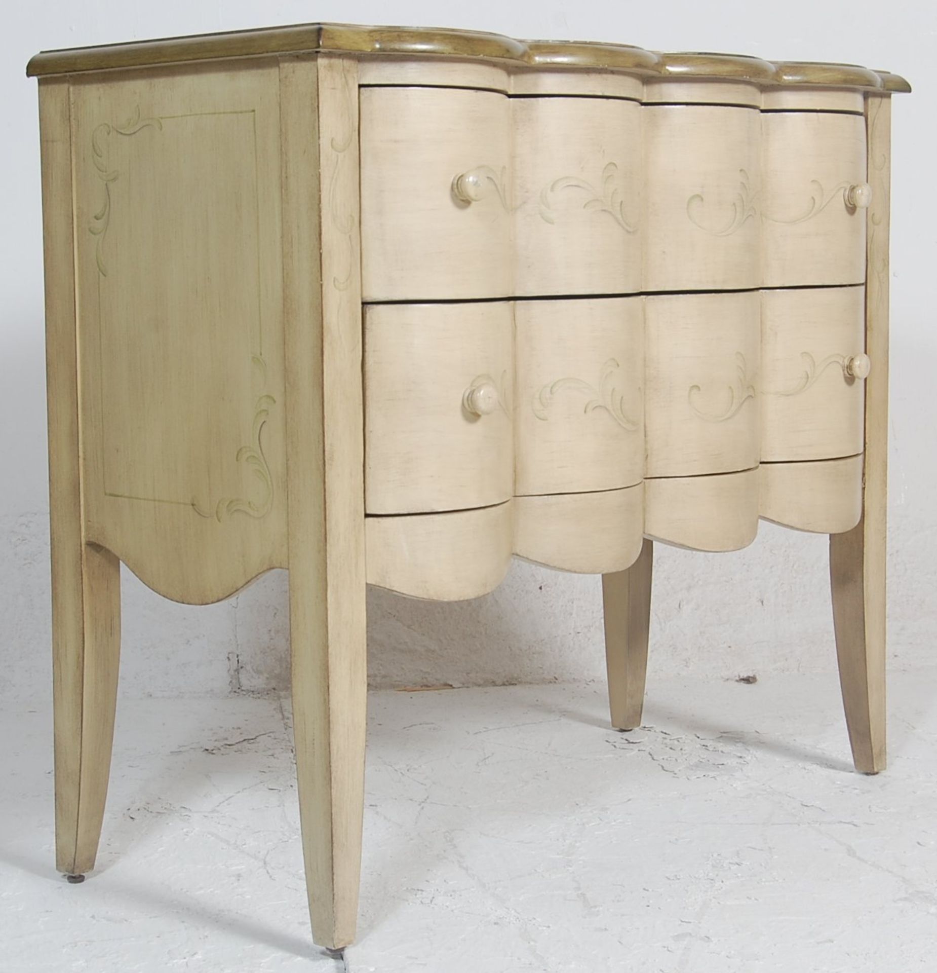 A 20th century Serpentine fronted French painted shabby chic commode chest of drawers. Raised on