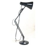 A vintage retro 20th Century anglepoise desk lamp having a round base with curved conical shade