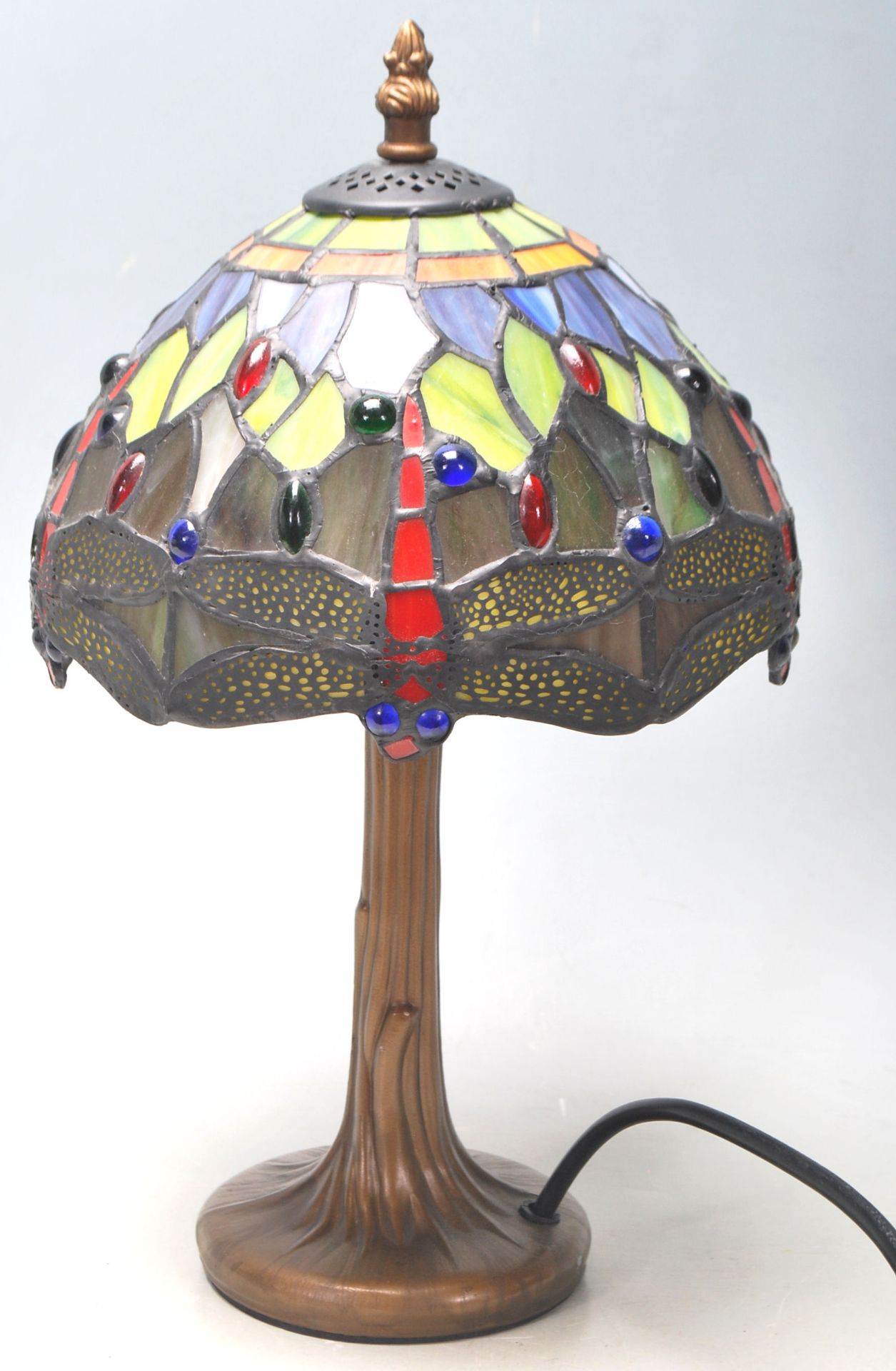A contemporary antique style antique Tiffany lamp having a round gilt base with a leaded coloured