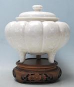 A 20th century Chinese ceramic  jar of gourd form having panelled decoration to the sides with