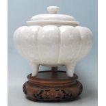 A 20th century Chinese ceramic  jar of gourd form having panelled decoration to the sides with