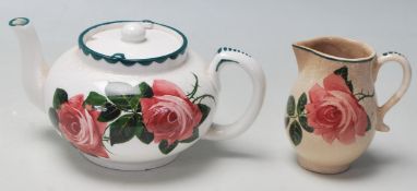 A rare early 20th century Bristol Poutney Rose pattern pottery ceramic teapot and matching creamer