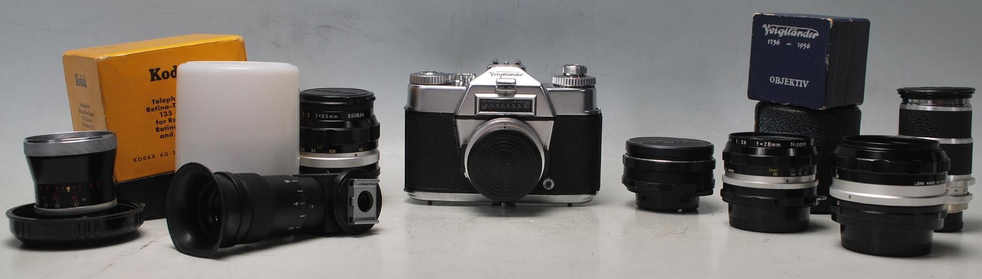 A vintage German Voigtländer camera along with spare lenses to include Nikkor S C auto 1:1.4 f=