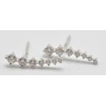 A pair of 18ct white gold seven stone graduated diamond drop earrings with butterfly and heart shape