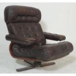 A mid century retro Danish inspired leather patchwork swivel chair - easy armchair. Raised on 4