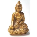 A small gilt cast bronze Chinese Oriental figurine in the form of Buddha seated in the lotus