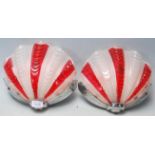 A pair of retro vintage 1960s glass shell wall light shades coloured in cherry and white having a